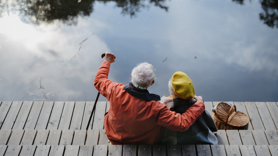 happy-senior-couple-at-autumn-walk-near-the-lake